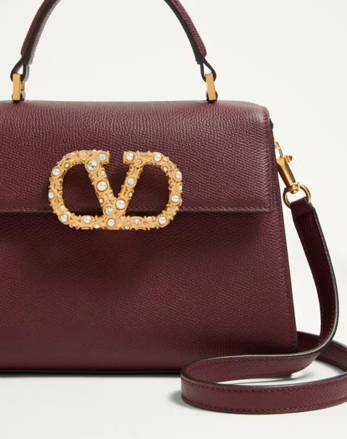 Μικρή τσάντα Valentino Garavani Vsling από δέρμα μοσχαριού με λογότυπο Jewel Μικρή τσάντα Valentino Garavani Vsling από δέρμα μοσχαριού με λογότυπο Jewel